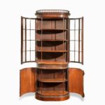A pair of mahogany shaped display cabinets attributed to Gillow open