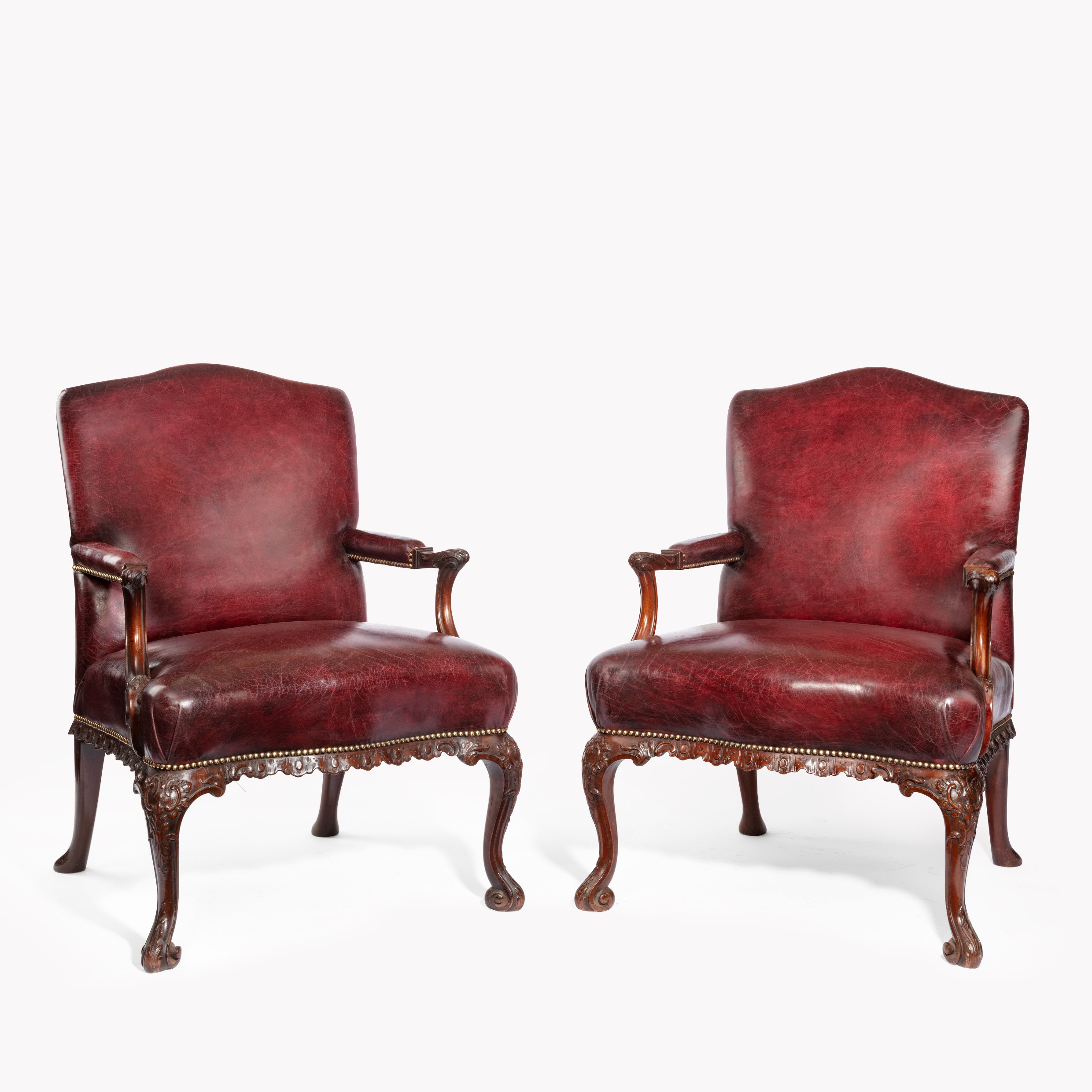 A pair late Victorian Mahogany open arm chairs in the Chippendale taste