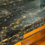 A late Regency portoro marble topped amboyna side cabinet top marble close up
