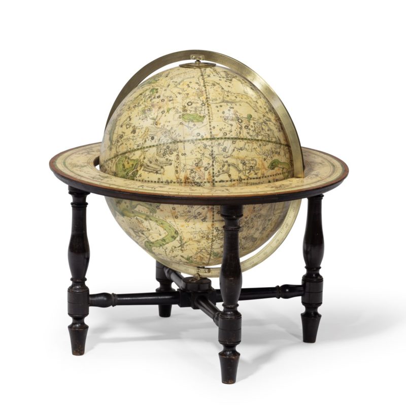 A 12 inch celestial table globe by Harris and Son, the horizon ring, with the original papers, set on four turned mahogany legs, the label stating ‘Improved Celestial Globe, the Stars laid down to the Year 1820. The days for the Average of the leap Years for 50 Years to come, by T Harris & Son, Opticians etc and by Henry Gardner, Opticians etc, Belfast, Published Janry 1st 1814.’ English, 1814.