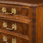 An unusual pair of early 20th century walnut serpentine commodes close up