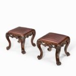 A pair of Victorian carved mahogany stools