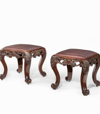 A pair of Victorian carved mahogany stools,