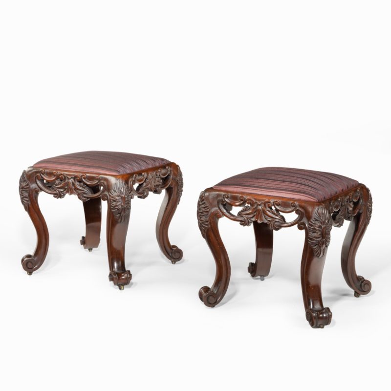 A pair of Victorian carved mahogany stools,
