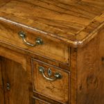 A George III Chippendale period mahogany chest of drawers, of typical form with a brushing slide above four graduated long drawers, with the original handles and bracket corner