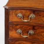 A flame mahogany George III serpentine chest of drawers handle detail