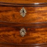 A flame mahogany George III serpentine chest of drawers lock detail