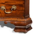 A flame mahogany George III serpentine chest of drawers foot detail