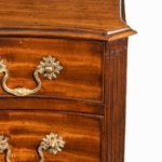 A flame mahogany George III serpentine chest of drawers corner detail
