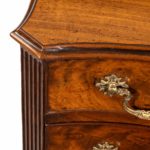 A flame mahogany George III serpentine chest of drawers front corner detail