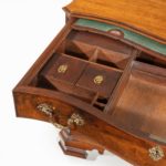A flame mahogany George III serpentine chest open details inside of drawers