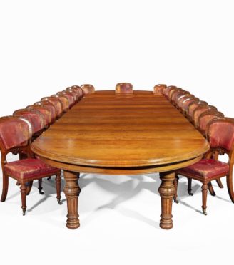 An extensive burled and figured pollard oak dining table by Gillows