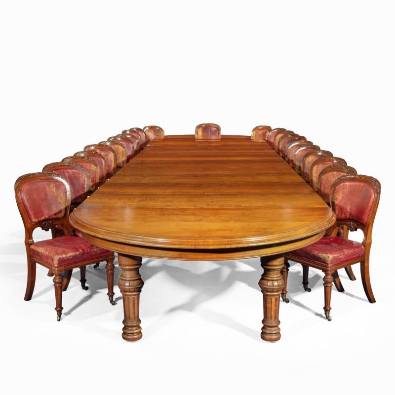 An extensive burled and figured pollard oak dining table by Gillows