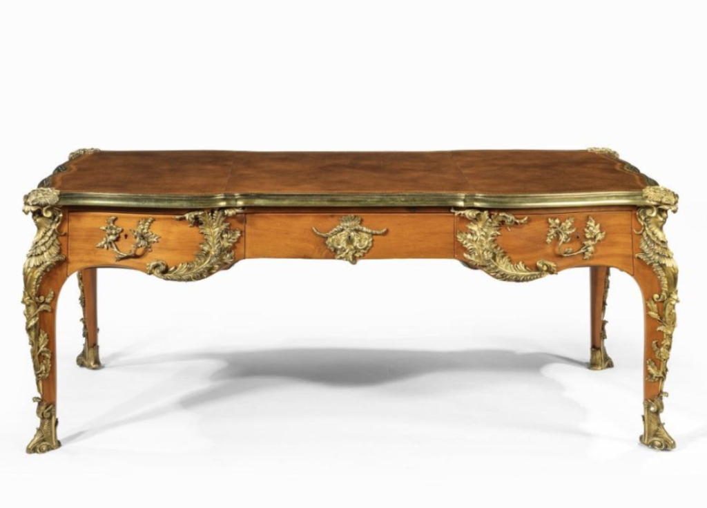 An outstanding Louis XV-style mahogany bureau plat after a model by Jacques B. Dubois, from the estate of Phyllis McGuire