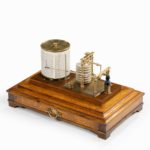 An Edwardian cased oak barograph with bevelled glass panels and a central chart drawer uncased