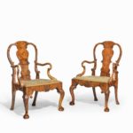 A pair of George II style walnut open arm chairs, possibly by Charles Tozer
