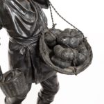 A Meiji period bronze of a vegetable seller detail