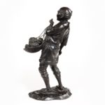 A Meiji period bronze of a vegetable seller side angle