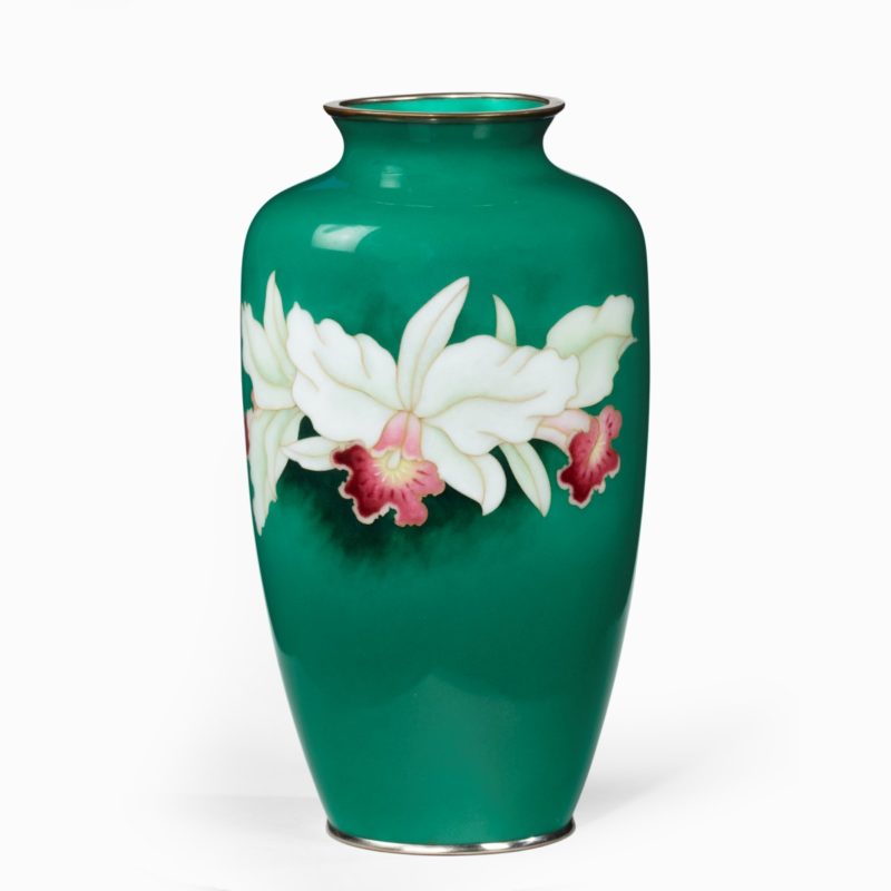 A Showa period tall deep green ground cloisonne vase, with three white and pink orchids, silvered metal mounts, Japanese, mid 20th century