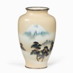 A Showa period rich cream ground musen cloisonne enamel vase with Mount Fuji by Ando