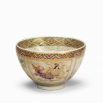 Satsuma earthenware tea bowl, the speckled greyish body decorated with four panels of alternating bijin and flowers, painted in overglaze enamels and gilt