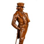A Victorian carved walnut figure of a fashionable gentleman side
