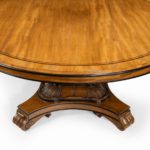 A George IV ebony-inlaid mahogany tilt-top centre table