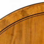 A George IV ebony-inlaid mahogany tilt-top centre table detail