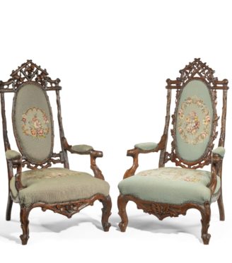 A pair of ‘Black Forest’ linden wood arm chairs