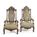 A pair of ‘Black Forest’ linden wood arm chairs pair