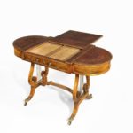 A Regency period rosewood sofa games table attributed to Gillows of Lancaster top open