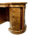 A Victorian kidney shaped desk in richly figured burr walnut Gillows drawers