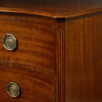 A George III mahogany serpentine chest of drawers corner