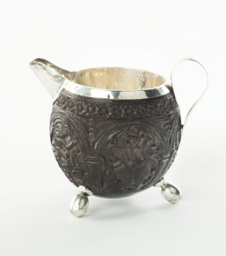 An Indian coconut shell milk jug