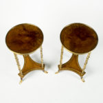A pair of Louis XVI style mahogany and ormolu gueridons top