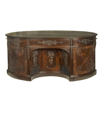 A very large mahogany centrepiece partners’ desk in the Chippendale style, attributed to Maples or Gillows
