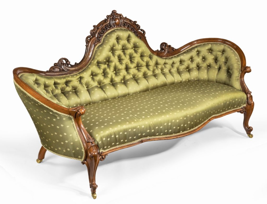 An elaborate Victorian shaped walnut sofa