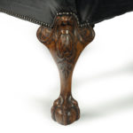 A generous late Victorian walnut wing arm chair leg detail