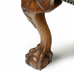 A generous late Victorian walnut wing arm chair leg details