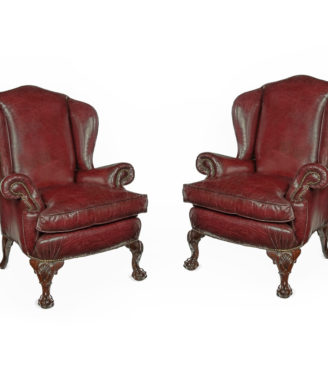 A pair of generous mahogany wing armchairs