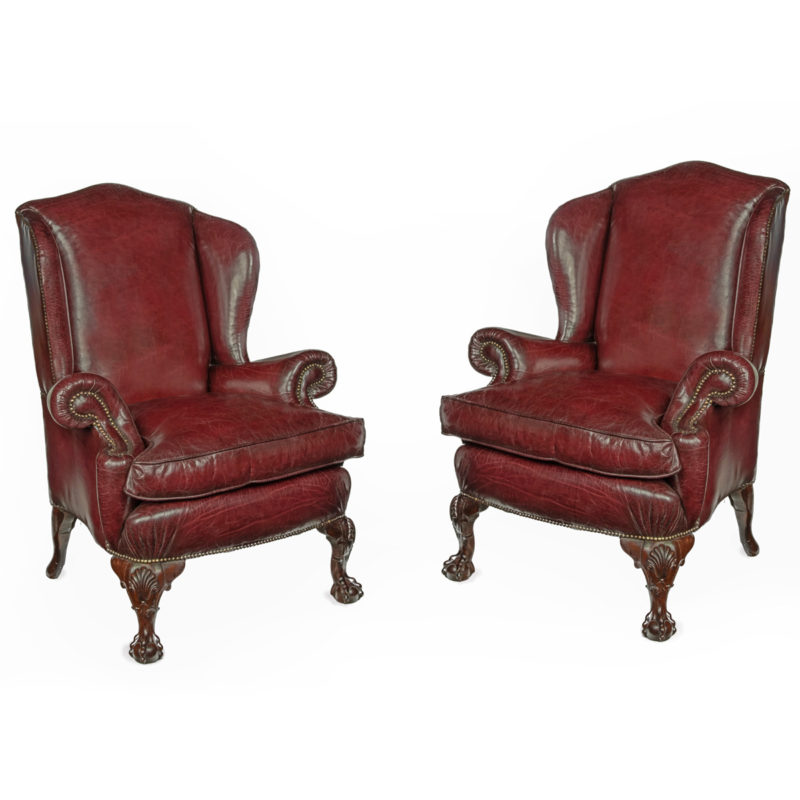 A pair of generous mahogany wing armchairs