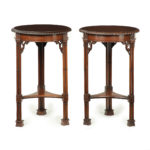 A pair of mahogany circular occasional tables in the Chippendale taste