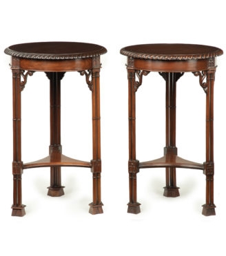 A pair of mahogany circular occasional tables in the Chippendale taste