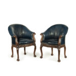 A pair of Victorian blue leather and walnut tub chairs