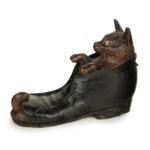 A Black Forest fruitwood carving of a cat in a boot
