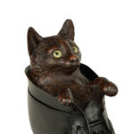 A Black Forest fruitwood carving of a cat in a boot detail