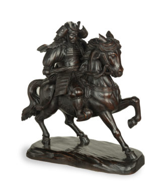 A powerful Japanese equestrian wood carving of a samurai by Yoshida Issen/Isshun