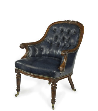 A Victorian blue leather oak library chair