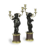 A pair of Egyptian porphyry and bronze candelabra after Charles-Antoine Bridan Pair