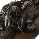 A very fine pair of ‘Black Forest’ walnut game plaques close up